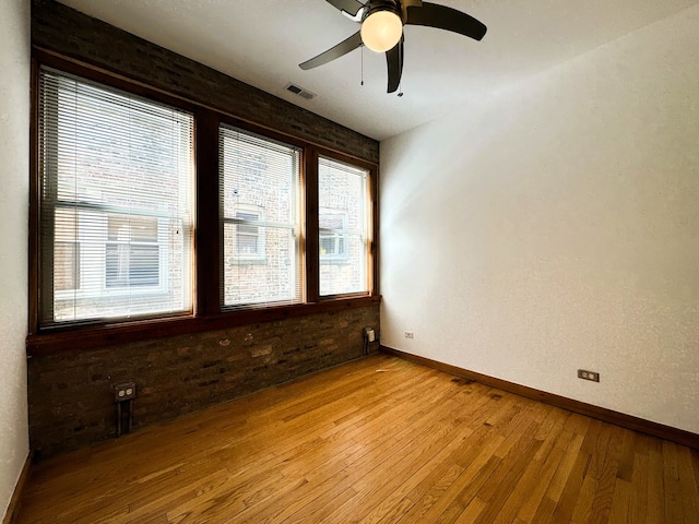 empty room with ceiling fan and light wood-type flooring