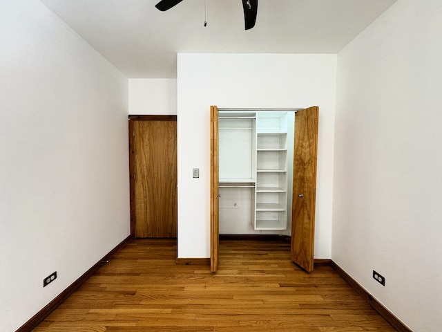 unfurnished bedroom with ceiling fan, light hardwood / wood-style floors, and a closet