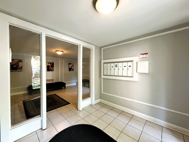 interior space with light tile patterned flooring and a mail area