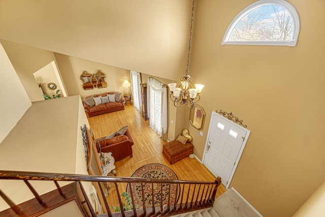 entryway with hardwood / wood-style floors and an inviting chandelier