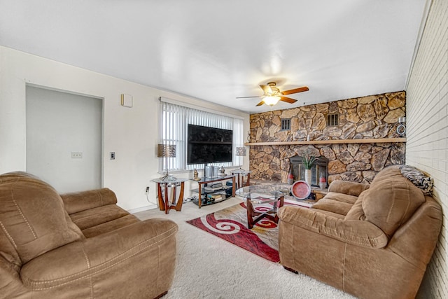 living room featuring carpet flooring, ceiling fan, and a fireplace