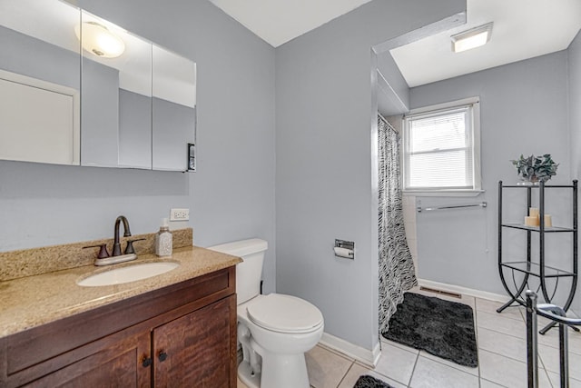 bathroom featuring tile patterned flooring, vanity, toilet, and walk in shower