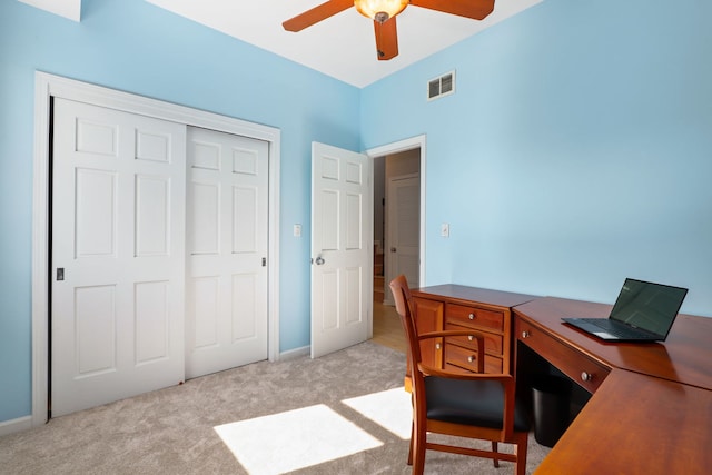 carpeted office space featuring ceiling fan