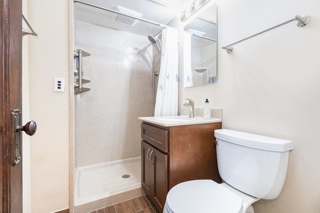 bathroom featuring a shower with shower curtain, vanity, toilet, and wood-type flooring