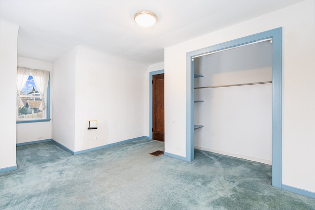 unfurnished bedroom featuring carpet floors and a closet