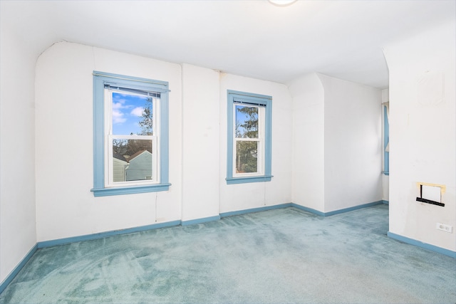 spare room with a healthy amount of sunlight and light colored carpet