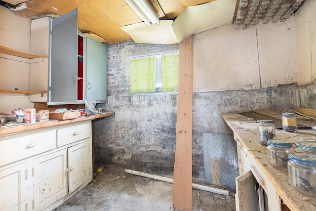 bathroom with a workshop area and concrete floors