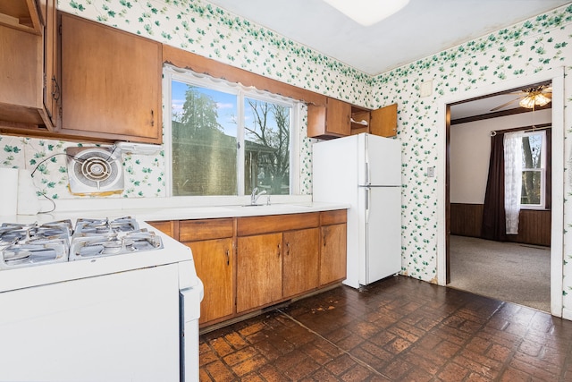 kitchen featuring white appliances and sink