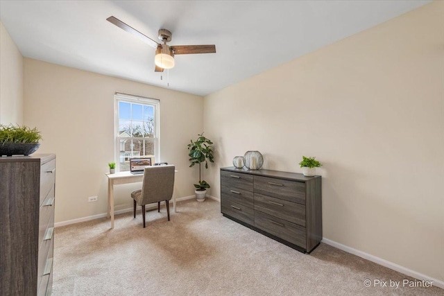 carpeted office space with ceiling fan