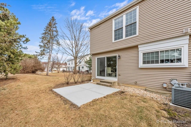 back of house with a yard, central AC unit, and a patio area