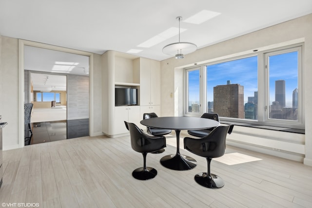 dining space with light hardwood / wood-style floors