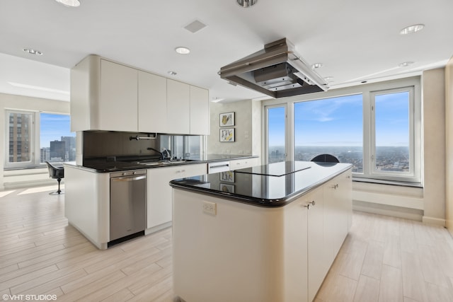 kitchen featuring white cabinetry, light hardwood / wood-style flooring, a kitchen island, and island range hood