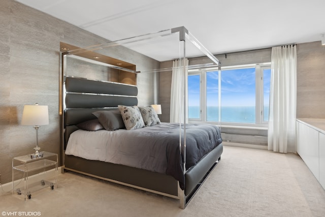 bedroom featuring carpet flooring and a water view