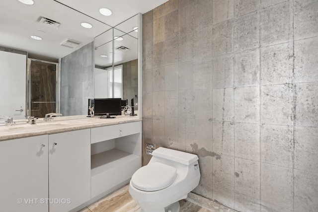 bathroom with hardwood / wood-style floors, vanity, toilet, and tile walls