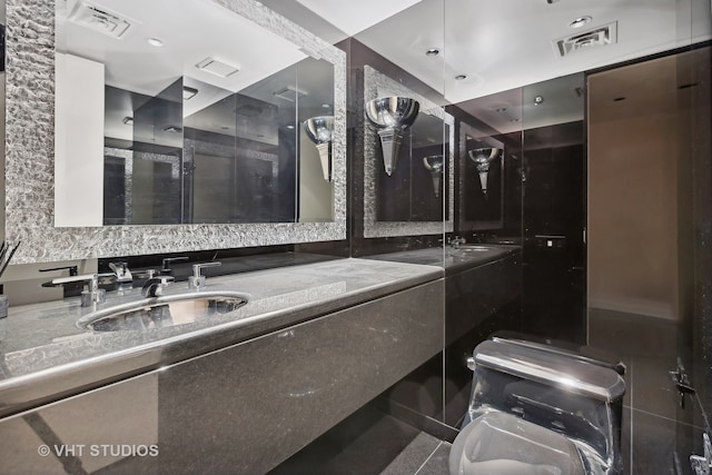 bathroom featuring vanity, toilet, and a shower