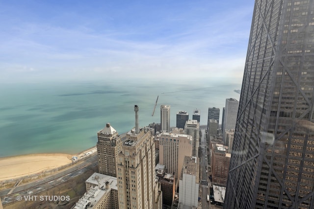 property's view of city featuring a beach view and a water view