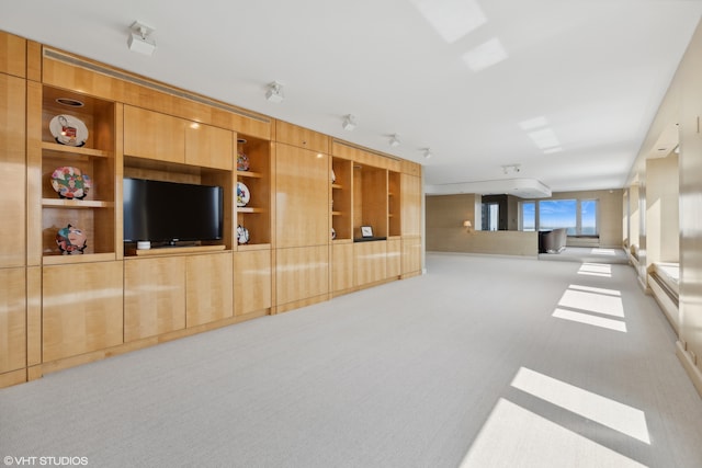 living room with a wall mounted air conditioner and light carpet