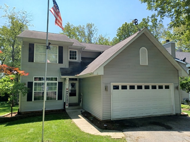 view of front of property with a garage and a front lawn