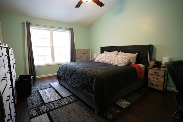 bedroom with vaulted ceiling, ceiling fan, and dark hardwood / wood-style floors