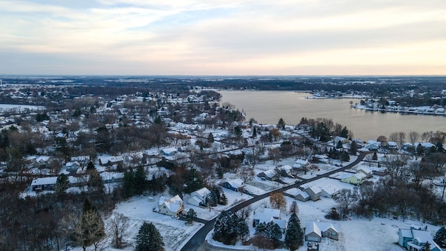 snowy aerial view with a water view