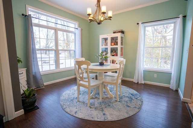 dining space featuring dark hardwood / wood-style flooring, crown molding, and a chandelier