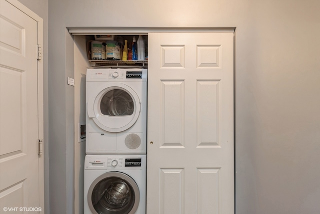 laundry area with stacked washing maching and dryer