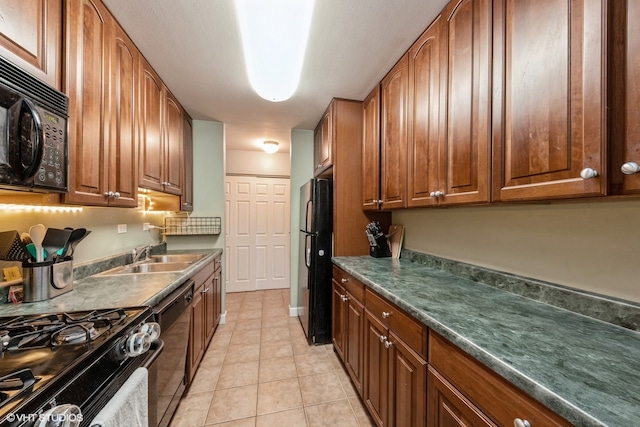 kitchen with light tile patterned flooring, sink, and black appliances