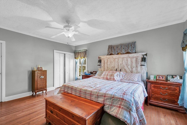 bedroom with ceiling fan, crown molding, a textured ceiling, and light wood-type flooring