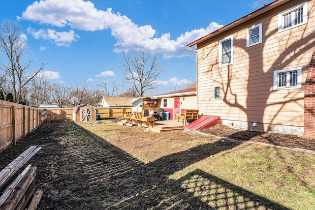 view of yard with a shed and a wooden deck