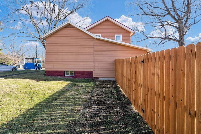 view of side of property with a lawn