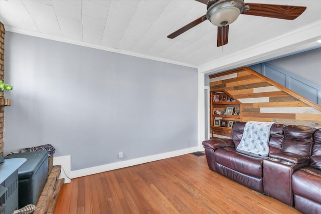 living room with hardwood / wood-style floors, ceiling fan, and ornamental molding