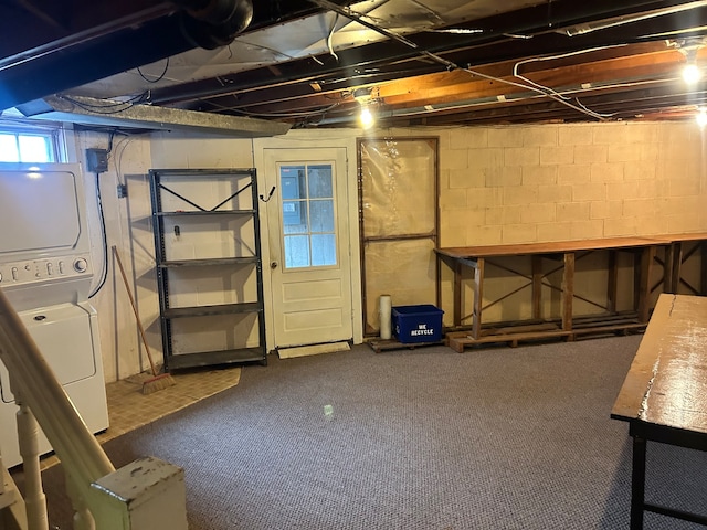 basement with carpet and stacked washer and dryer