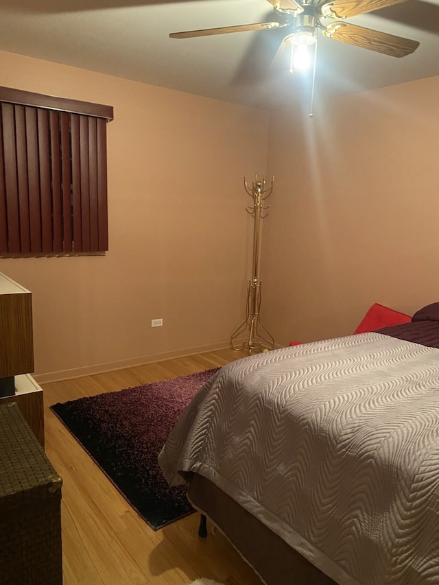 bedroom with ceiling fan and wood-type flooring