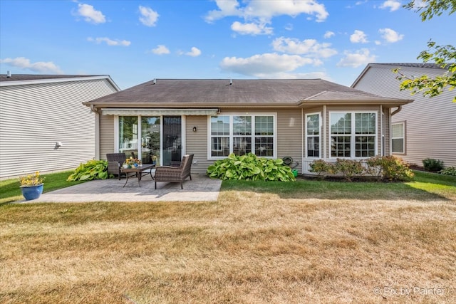 rear view of property featuring a patio area and a yard