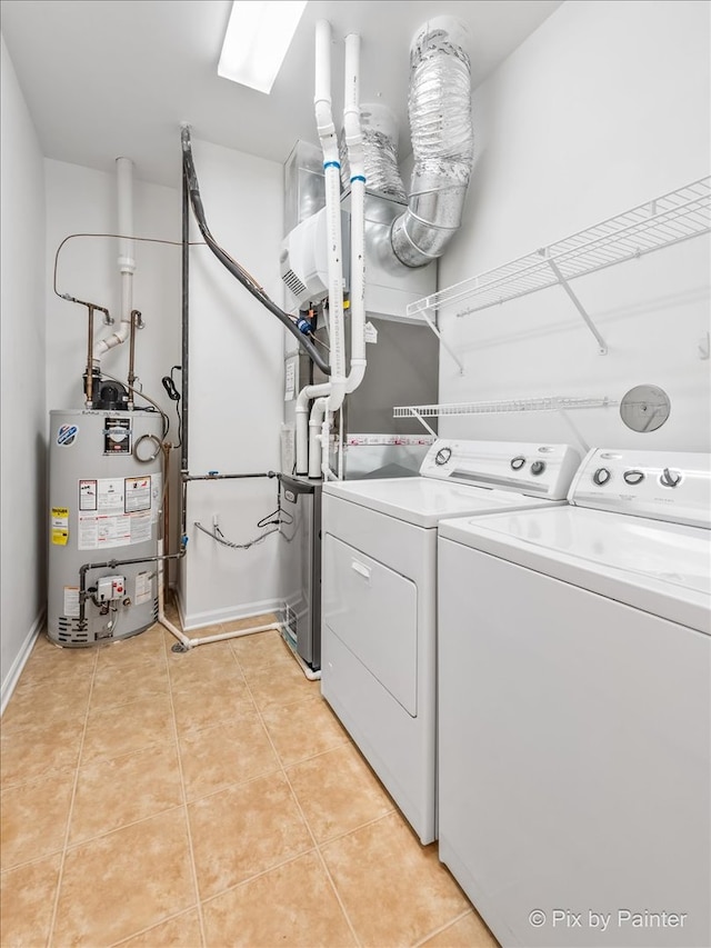 laundry room featuring light tile patterned flooring, separate washer and dryer, and water heater