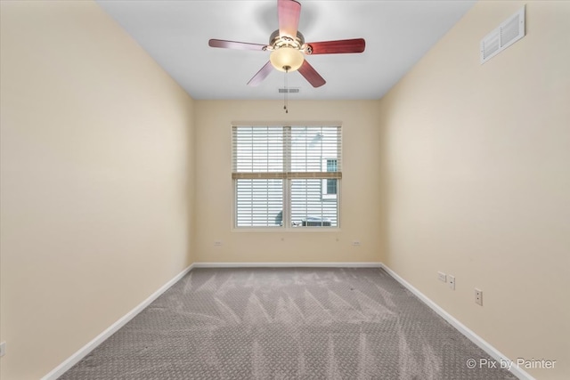 empty room featuring ceiling fan and light carpet