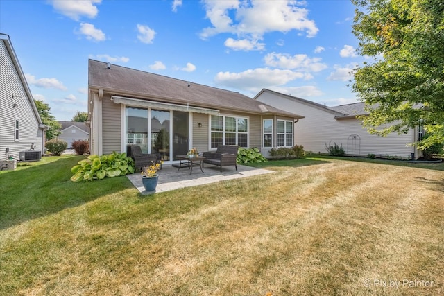 back of property featuring a patio, central AC, and a lawn