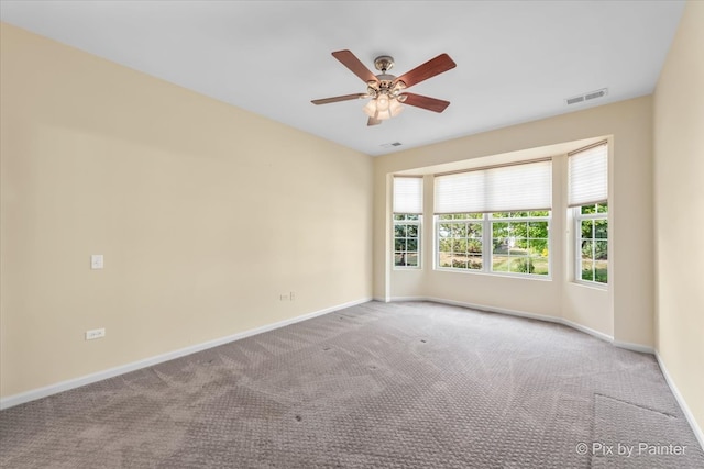 carpeted empty room featuring ceiling fan