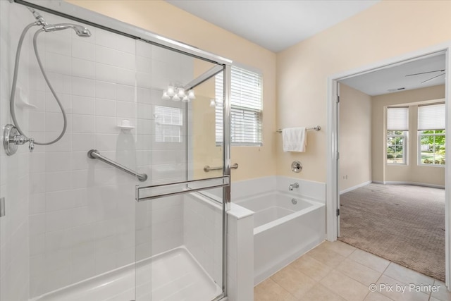 bathroom with tile patterned flooring, a healthy amount of sunlight, and independent shower and bath