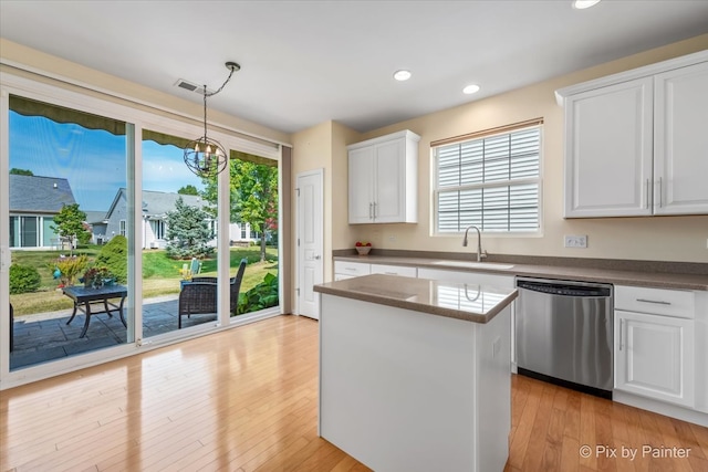 kitchen with white cabinets, sink, an inviting chandelier, dishwasher, and hanging light fixtures