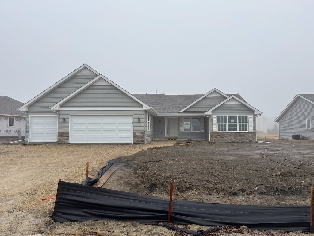 ranch-style house featuring driveway and an attached garage