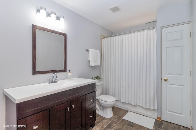 full bathroom with vanity, shower / bathtub combination with curtain, and toilet