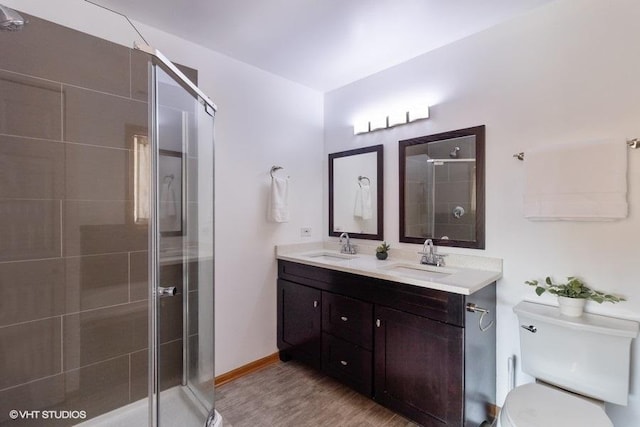 bathroom with walk in shower, vanity, toilet, and hardwood / wood-style floors