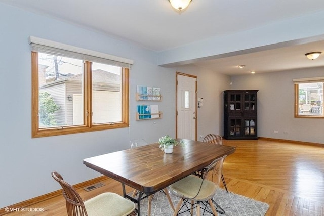 dining space with light hardwood / wood-style floors