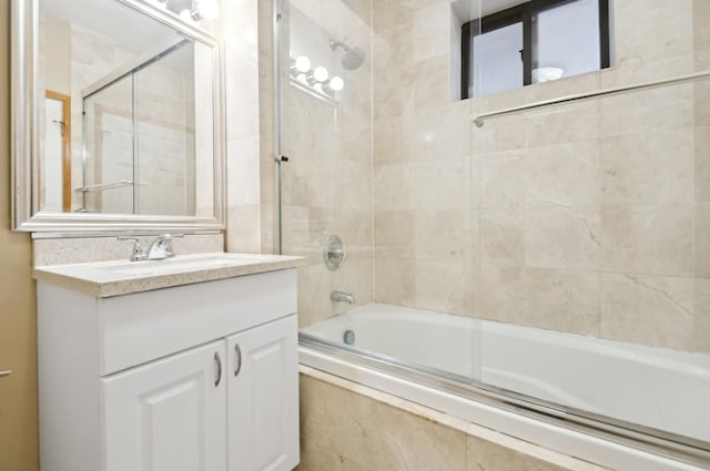 bathroom featuring vanity and combined bath / shower with glass door