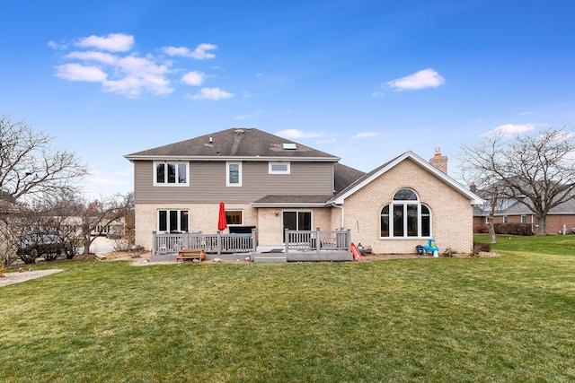 back of house with a yard and a deck