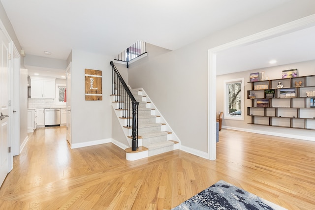 stairs with hardwood / wood-style floors