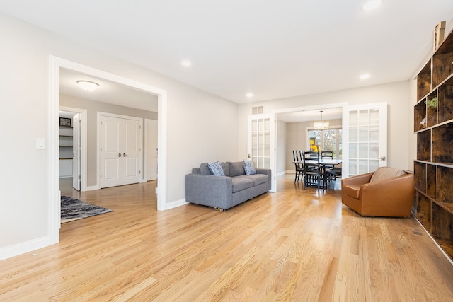 living room with light hardwood / wood-style floors and french doors