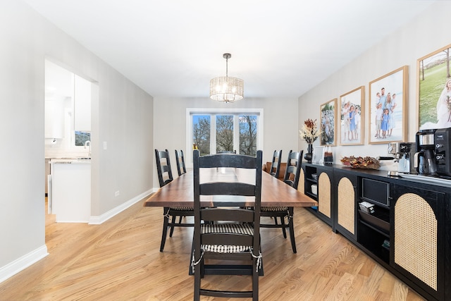 dining room featuring a chandelier and light hardwood / wood-style flooring