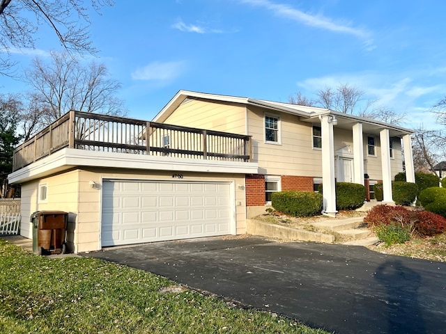 view of front of property featuring a balcony and a garage